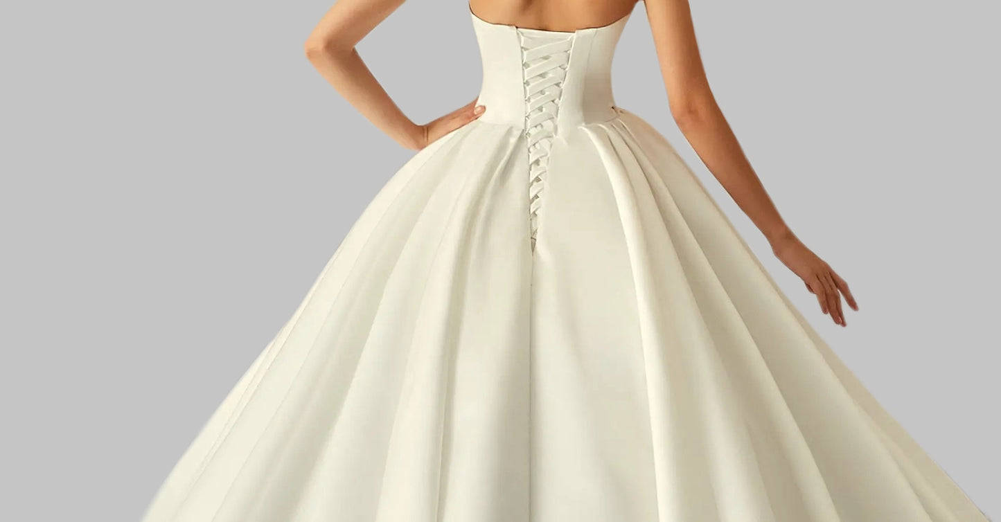 Elegant Satin A-Line Wedding Dress with Bow Detail and Dramatic Train